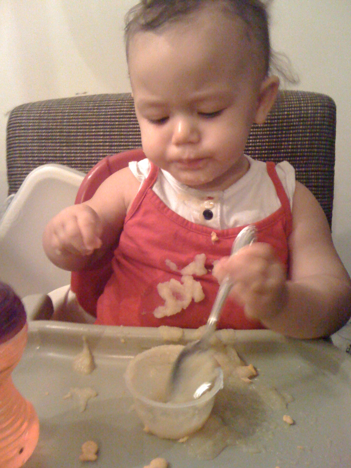 Feeding herself applesauce